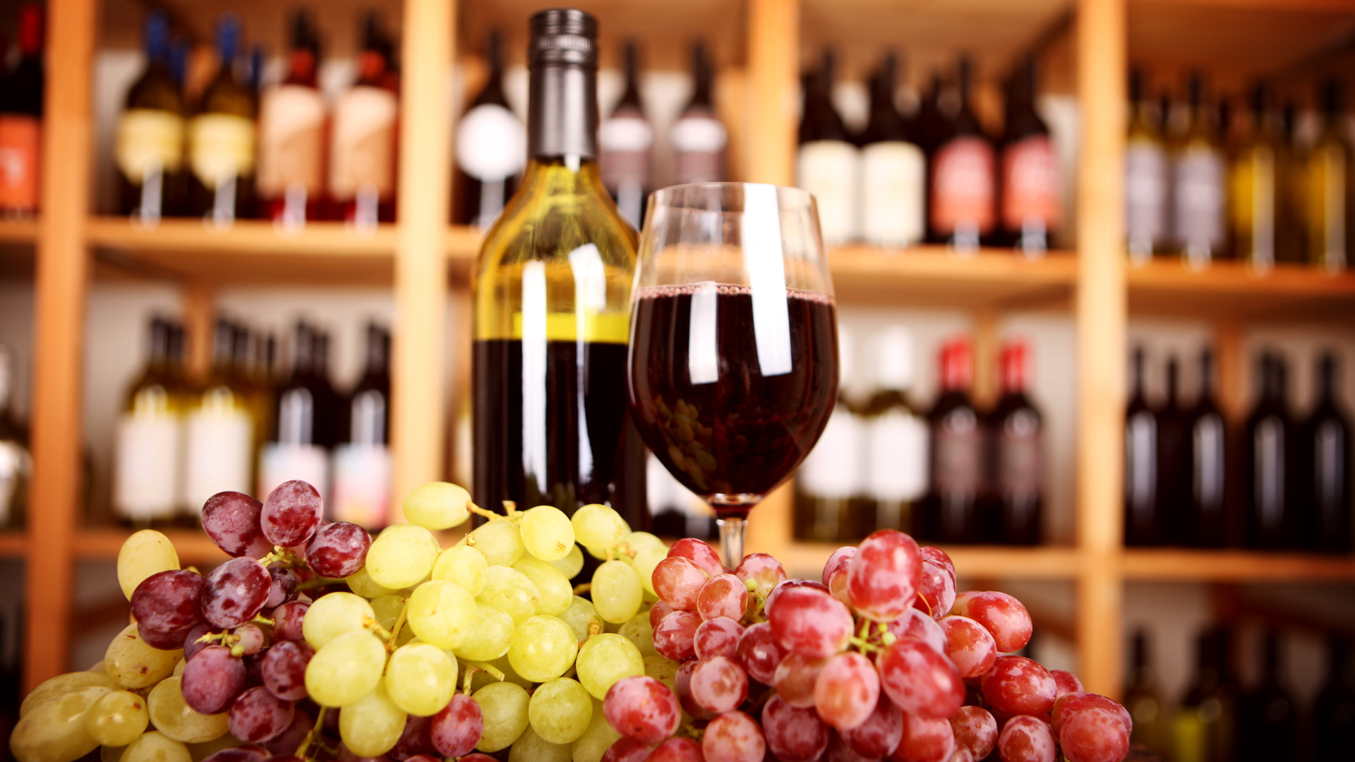 Selection of red and white wines in wine glasses and bottles
